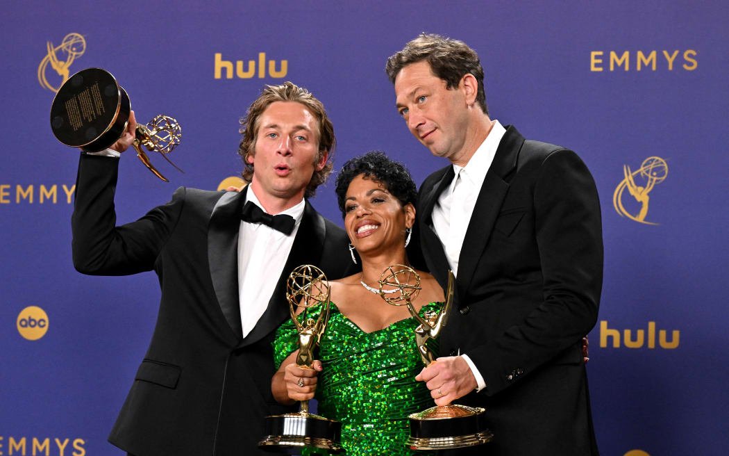 American actor Jeremy Allen White (right) poses in the press room with the award for Outstanding Actor in a Comedy Series.